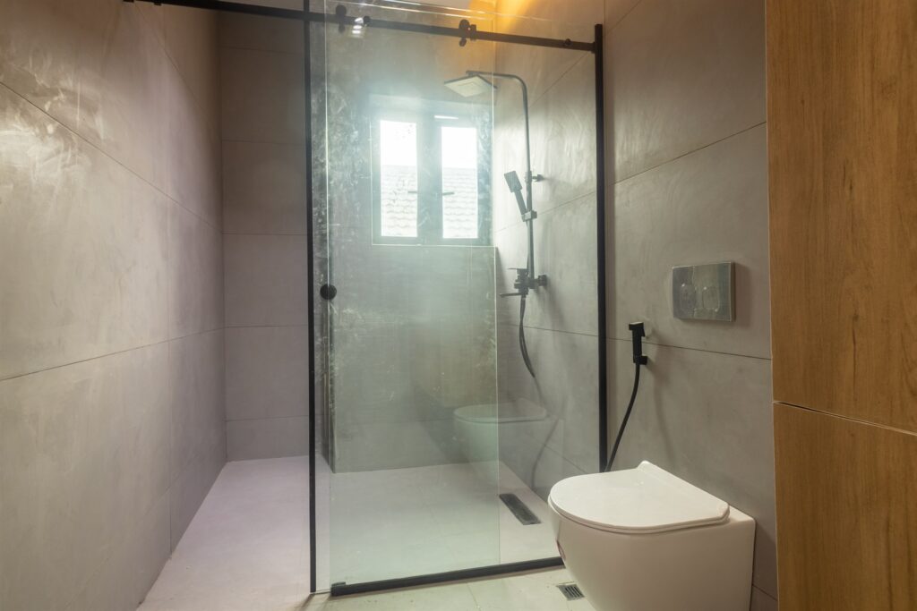 Brum Height 9: Bathroom with a glass-enclosed shower and toilet